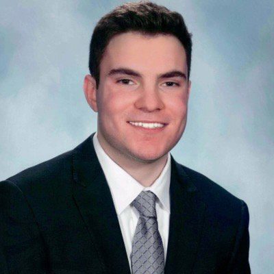 Smiling young man in dark suit portrait